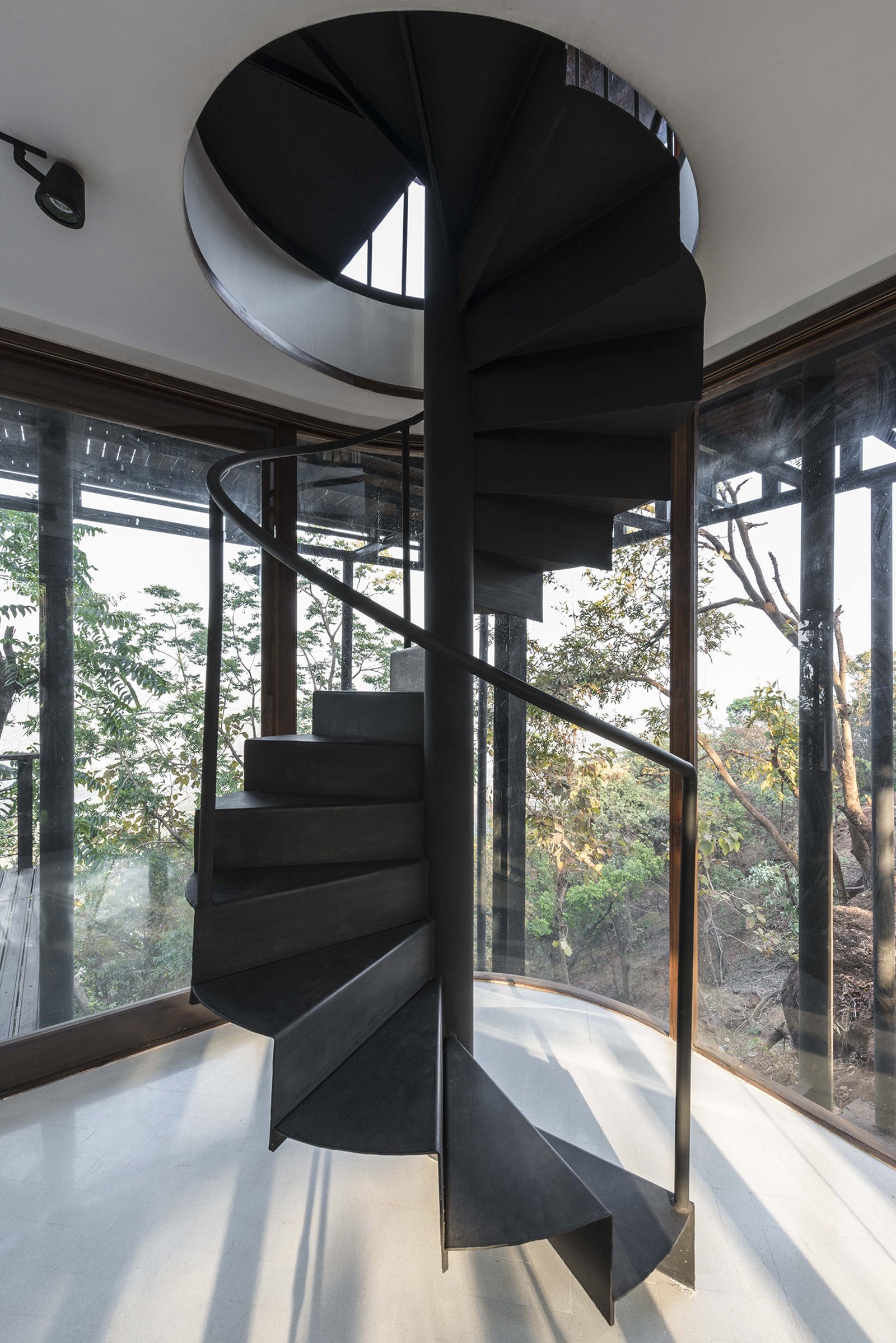 black spiral staircase at tala treehouse villa alibaug india