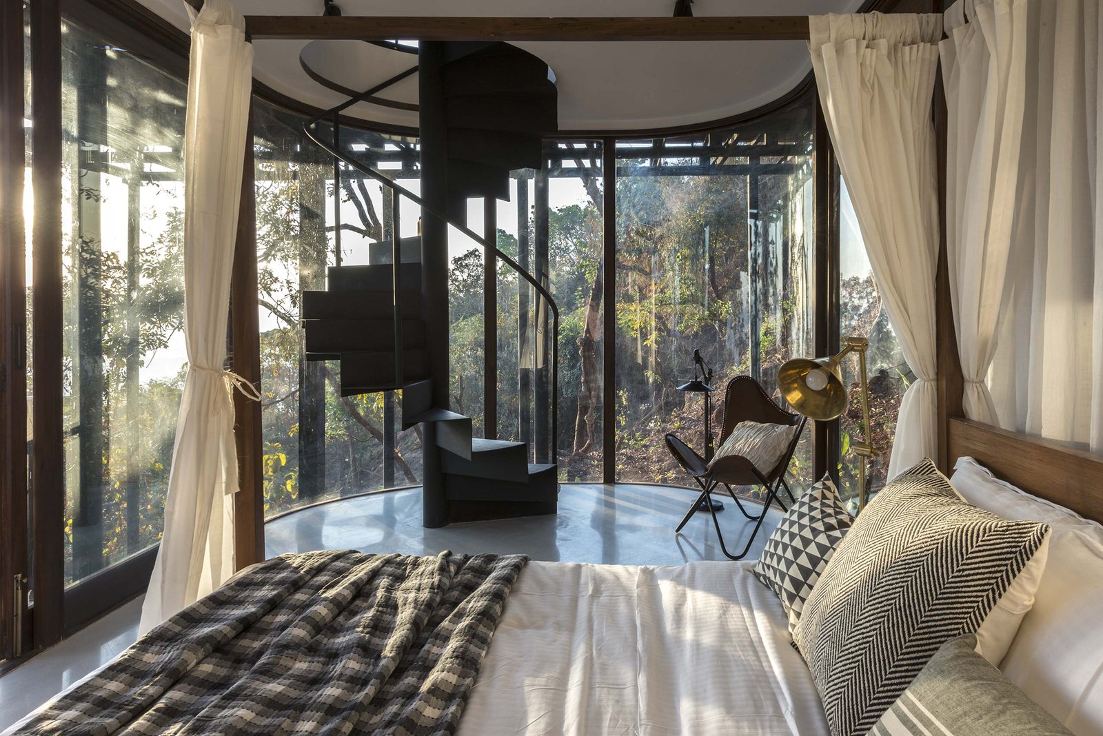 bedroom with curved glass tala treehouse villa alibaug india